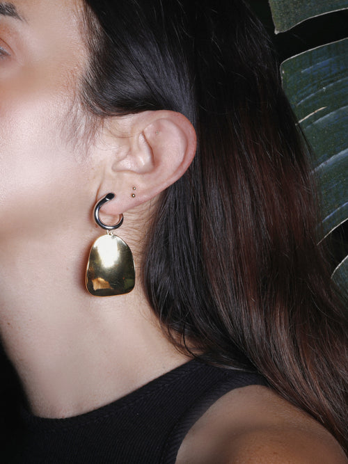 detail shot of MOUNSER Zest Earrings in Gold mixed- metal curved sculptural earring