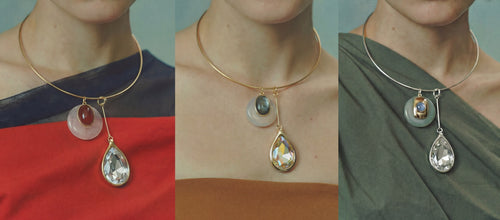 Three models wearing the MOUNSER Rega Collar Necklace in Amarena, Champagne and Cucumber colorways, featuring natural gemstone disc pendants and Swarovski Austrian crystal teardrop drops on gold and rhodium-plated brass collars, inspired by 70s Italian design, handcrafted in Los Angeles.