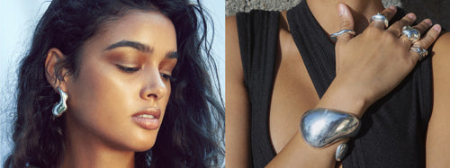 Model wearing MOUNSER sculptural sterling silver art object jewelry.  Free form cuff bracelets, layered hoop earrings and silver statement rings.  Art object jewelry handcrafted in Los Angeles.