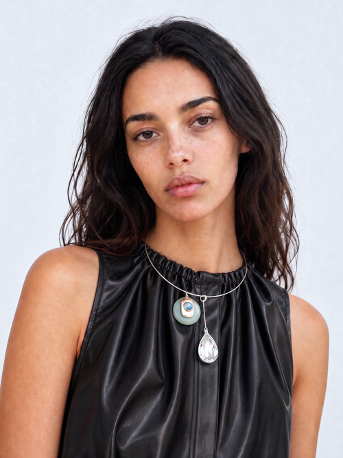 Model wearing the MOUNSER Rega Collar Necklace in Cucumber with jade and crystal pendants, on a rhodium plated brass wire collar necklace.