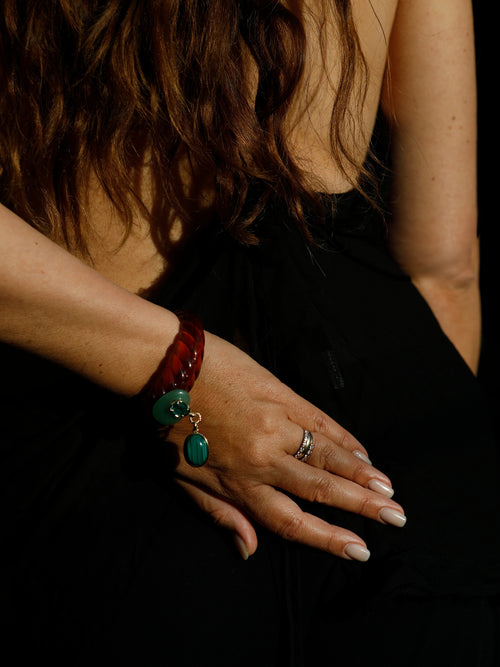 MOUNSER Scallop Drop Cuff in Tortoise Shell worn as a stacked statement bracelet, featuring an amber brown sculptural resin silhouette with malachite drop