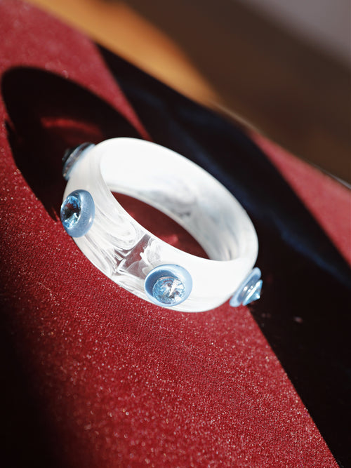 detail shot of the MOUNSER Ambrosia Bangle highlighting vivid Austrian crystals set into polished blue resin.