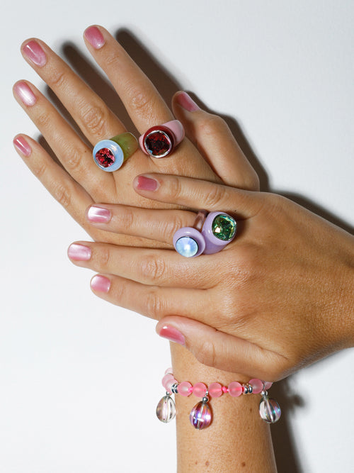 Hand shot of MOUNSER Disco Ring in Anthocyanin featuring colorful acrylic resin and Swarovski crystal gemstone