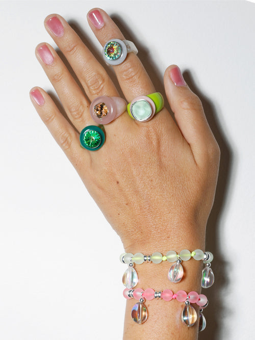 Hand shot of MOUNSER Disco Ring in Verdant featuring colorful acrylic resin and Swarovski crystal gemstone