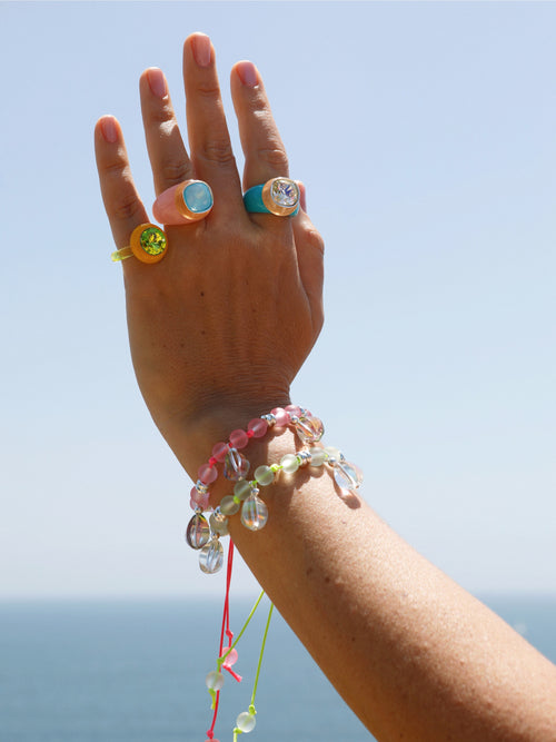 Model shot of MOUNSER Disco Ring in Yuzu featuring colorful acrylic resin and Swarovski crystal gemstone