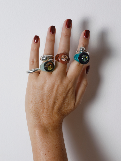 Close-up of the MOUNSER Bliss Ring in Wintergreen on hand: green crystal with natural gemstone halo in sterling silver.