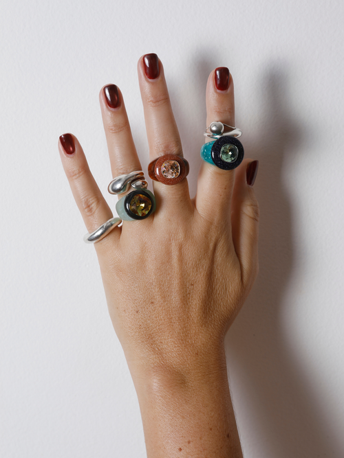 MOUNSER Bliss Ring in Wintergreen worn with stacked rings, styling a teal resin statement ring.