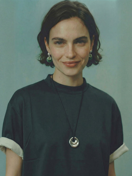Model wearing MOUNSER Isle Earrings in Comber Green - green jade and Austrian crystal drop earrings with sterling silver post styled with coordinating MOUNSER necklace