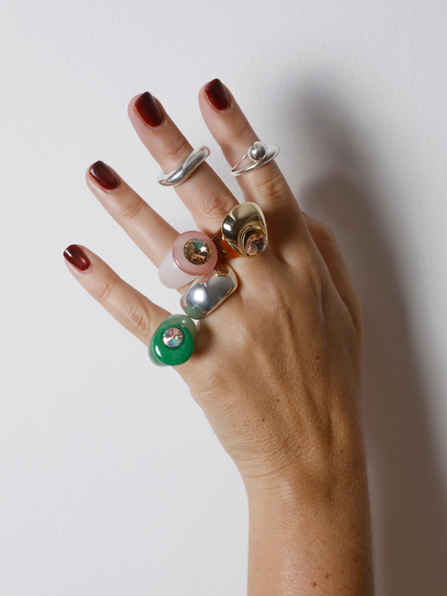 MOUNSER Mylar Ring in Gold worn with colorful ring stacks, styling a brown and gold sculptural ring.