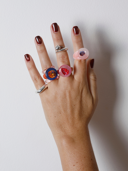MOUNSER Orbital Ring in Pink Aurora worn with ring stack, styling a pink gemstone ring.