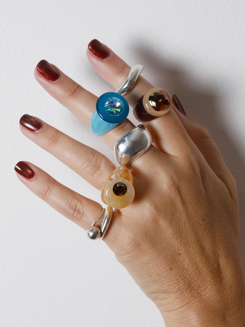 MOUNSER Orbital Ring in Silica worn with ring stack, styling a beige gemstone ring.