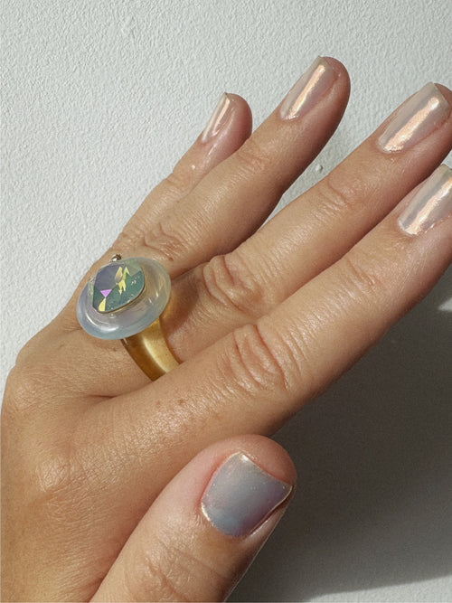 Detail shot of MOUNSER Raw Gradient Cellophane Ring in Crystalline Veil featuring an irridescent cushion-cut Austrian crystal and acrylic resin band 