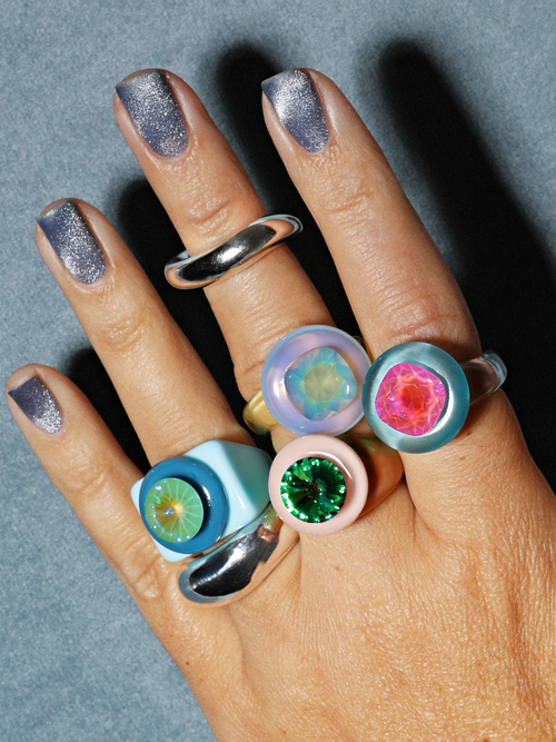 Studio shot of MOUNSER Raw Gradient Cellophane Ring in Opalescent Aurora featuring a Swarovski crystal and acrylic resin band