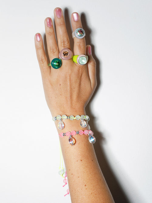 On hand shot of MOUNSER Ring Pop in Honey Dew colorful sculptural cocktail ring.