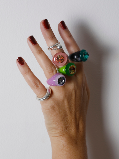 Hand wearing the MOUNSER Ring Pop in Mesclun on the finger with ring stacks showing the statement ring’s size and scale.