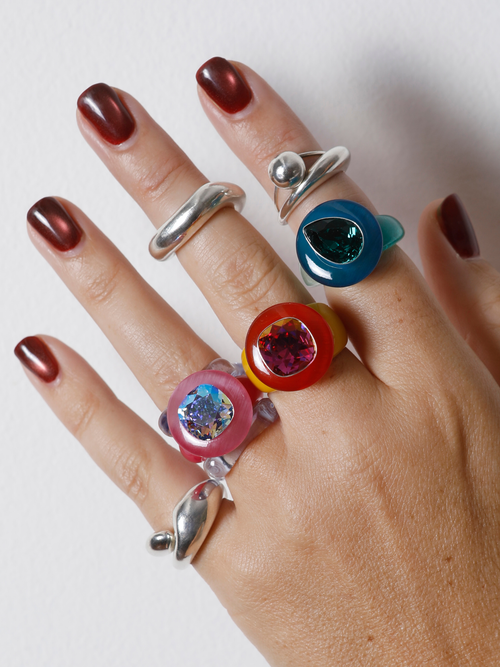 MOUNSER Ring Pop in Red Lantana worn with ring stacks, styling a colorful resin statement ring.