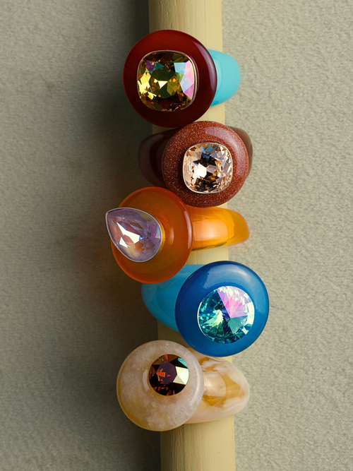 MOUNSER Ring Pop in Starfish, a candy-colored turquoise and yellow cocktail ring in a still life, colorful ring stack handcrafted in Los Angeles.