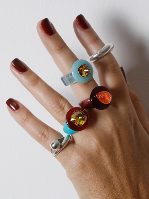 MOUNSER Ring Pop in Starfish worn with ring stacks, styling a colorful resin statement ring.