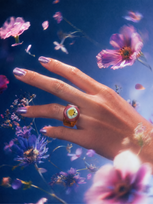 MOUNSER Spectrum Ring in Dark n Stormy worn on model's hand — milky brown limited edition cocktail ring with iridescent Austrian crystal on a blue floral background,  art object jewelry handcrafted to order in Los Angeles.