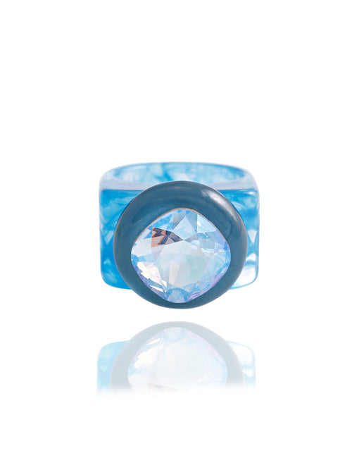 MOUNSER Spectrum Ring in Sleeping Beauty — milky blue hand-polished acrylic resin cocktail ring with iridescent cushion-cut Austrian crystal center stone, forward facing view.