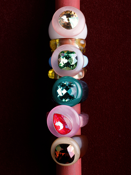  MOUNSER Tears of Joy Ring in Heat Wave, a pink pear-shaped crystal ring in a still life styled in a ring stack.  Colorful statement jewelry handcrafted in LA.
