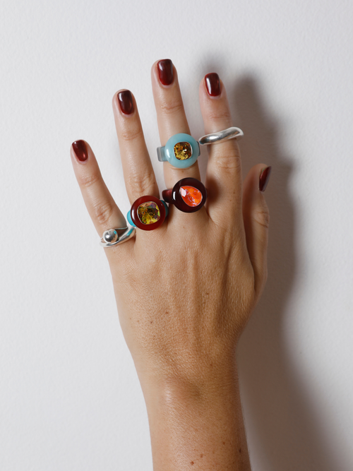 Hand wearing the MOUNSER Tears of Joy Ring in King Crab on the finger in a ring stack, showing the statement ring’s size and scale.