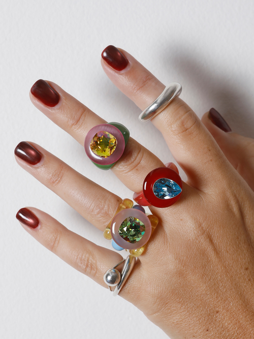 MOUNSER Tears of Joy Ring in Wedgewood worn with colorful acrylic rings and sterling silver, styling bold resin statement rings.