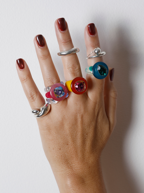 Hand wearing the MOUNSER Tears of Joy Ring in Yacht Club on the finger in a ring stack, showing the statement ring’s size and scale.