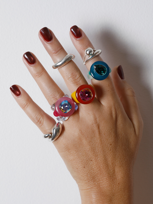 MOUNSER Tears of Joy Ring in Yacht Club worn with colorful acrylic rings and sterling silver, styling bold resin statement rings.