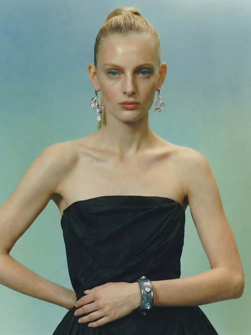 Studio shot of the MOUNSER Ambrosia Bangle displaying its curved sculptural silhouette and glossy finish.