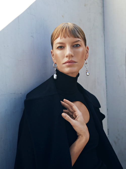 model shot of MOUNSER Found Object Hoop Earrings in Silver sculptural sterling silver hoop earring with fresh water pearl drop charm
