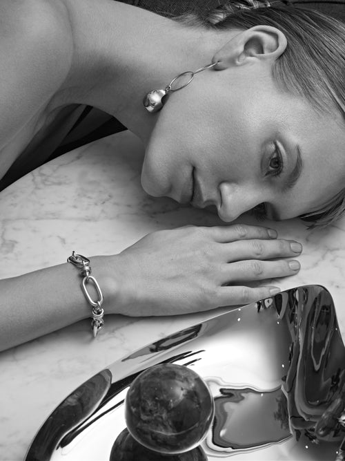 detail shot of MOUNSER Hops Bracelet in Silver a luminous rhodium plated brass chunky chain with sculptural disc charm