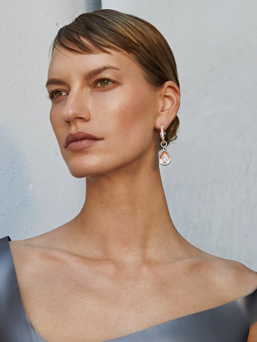 model shots of MOUNSER Hyacinth Hoop Earrings pavé hoops with asymmetric floating crystal and orb drops.
